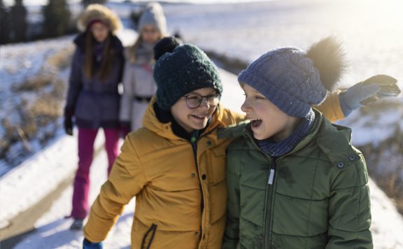 Family enjoy walking on a sunny winter day