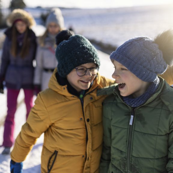 Family enjoy walking on a sunny winter day